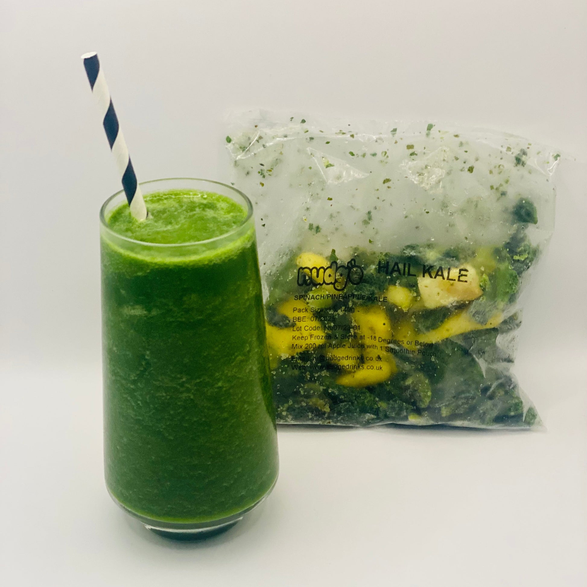 Nudge hail kale frozen smoothie in glass with 140 gram sachet of spinach, pineapple and kale